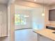 Bright dining area featuring large window and decorative trim, adjacent to the kitchen island at 4841 Walkers Green, Mableton, GA 30126