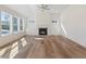 Sunlit living room with hardwood floors, fireplace, and built-in shelving at 212 Harvest Trl, Hiram, GA 30141