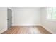 Bright bedroom with wood floor, white trim and a gray door at 220 Hicks Se Dr, Marietta, GA 30060