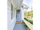 Welcoming front porch with a gray door, stylish bench, and charming details for added curb appeal at 220 Hicks Se Dr, Marietta, GA 30060