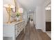 Long hallway with decorative table, modern lighting, and wood look flooring at 1341 Cedarcrest Blvd, Acworth, GA 30101
