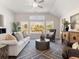 Open-concept living room with high ceilings, stylish furniture, and plenty of natural light at 1341 Cedarcrest Blvd, Acworth, GA 30101