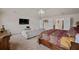 View of the main bedroom with bed, TV, sitting area, and chandelier at 235 Silver Ridge Rd, Covington, GA 30016