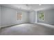 Spacious bedroom with gray carpeting and two windows at 1015 Nawench Dr, Atlanta, GA 30327