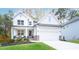 Two story white farmhouse with stone accents and landscaped yard at 51 Riverbirch Way, Dallas, GA 30157