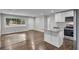 Open concept kitchen with island, hardwood floors, and stainless steel appliances at 1625 Austin Dr, Decatur, GA 30032