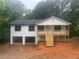 Charming home featuring a two-car garage, white siding, and a welcoming front porch with wooden stairs at 22 High Pointe Dr, White, GA 30184