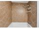 Clean bathroom with a white tub and light brown tile surround at 1284 Piedmont Ne Ave # 5, Atlanta, GA 30309
