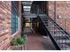 Exterior side view of building with stairs leading to upper level over a brick patio at 1284 Piedmont Ne Ave # 5, Atlanta, GA 30309
