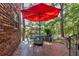 Outdoor patio featuring red umbrella, table and chairs next to red brick building at 1284 Piedmont Ne Ave # 5, Atlanta, GA 30309