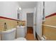 Bathroom with classic yellow tile, white fixtures, and a window at 1350 Ruth, Decatur, GA 30035
