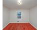 A minimalist bedroom features a hardwood floor and a single window at 1350 Ruth, Decatur, GA 30035