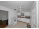 The kitchen has white cabinets, tiled floors and laminate countertops at 1350 Ruth, Decatur, GA 30035