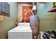 Laundry area featuring a washing machine and water heater at 1350 Ruth, Decatur, GA 30035