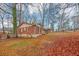 A red brick home sits on a lot with plenty of trees in the background at 1350 Ruth, Decatur, GA 30035