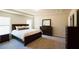 Large main bedroom with plush carpeting and dark wood furniture at 372 Bloomfield Cir, Canton, GA 30114