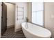 Relaxing bathroom with soaking tub and black matte fixtures at 585 Bismark Ne Rd, Atlanta, GA 30324