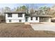 Ranch style home with white siding, teal door and carport at 6990 Factory Shoals Rd, Austell, GA 30168