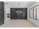 Dining area featuring a modern light fixture, wood-look floors, and a statement accent wall at 555 Versailles Dr, Auburn, GA 30011