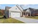 Gray and brick home with white accents, 2-car garage, and landscaping at 2760 Marie Way, Cumming, GA 30028