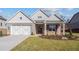 Gray brick home with white accents, 2-car garage, and landscaping at 2760 Marie Way, Cumming, GA 30028