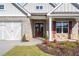 Double wooden doors with sidelights and stone accents at 2760 Marie Way, Cumming, GA 30028
