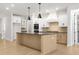 Modern kitchen with island, stainless steel appliances, and light wood cabinets at 2760 Marie Way, Cumming, GA 30028