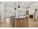 Modern kitchen with island, stainless steel appliances, and light wood cabinets at 2760 Marie Way, Cumming, GA 30028