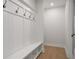 White mudroom with bench and hooks for coats at 2760 Marie Way, Cumming, GA 30028