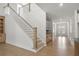 Elegant staircase with wooden railings and hardwood floors at 2760 Marie Way, Cumming, GA 30028