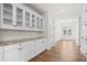 Butlers pantry with white shaker cabinets, granite countertop, and glass-front uppers at 2780 Marie Way, Cumming, GA 30028