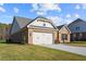 Brick house with a two-car garage and side yard at 2780 Marie Way, Cumming, GA 30028