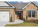 Front entrance with double doors and brick facade at 2780 Marie Way, Cumming, GA 30028