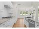 Bright kitchen with white cabinets, granite counters, and stainless steel appliances at 2780 Marie Way, Cumming, GA 30028