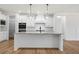 Modern kitchen with white cabinets and large island at 2780 Marie Way, Cumming, GA 30028