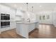 Modern kitchen with white cabinets and large island at 2780 Marie Way, Cumming, GA 30028