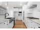 Modern kitchen with granite countertops, stainless steel appliances, and white cabinetry at 2780 Marie Way, Cumming, GA 30028