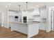Modern kitchen with white cabinets and large island at 2780 Marie Way, Cumming, GA 30028