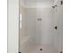 Large walk-in shower with neutral tile and built-in seat at 2780 Marie Way, Cumming, GA 30028
