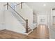 View from the main level showcasing the staircase and hardwood floors at 2780 Marie Way, Cumming, GA 30028