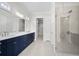 Modern bathroom with navy blue vanity, dual sinks, and glass shower at 2735 Marie Way, Cumming, GA 30028