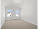 Bright bedroom with neutral carpeting and two windows at 2735 Marie Way, Cumming, GA 30028