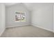 Spacious bedroom with carpeted floors and large window at 2735 Marie Way, Cumming, GA 30028