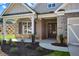 Covered front porch with stone accents and double front doors at 2735 Marie Way, Cumming, GA 30028