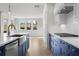 Open concept kitchen with white cabinets and stainless steel appliances at 2735 Marie Way, Cumming, GA 30028