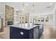 Island kitchen with blue cabinetry and stainless steel appliances at 2735 Marie Way, Cumming, GA 30028