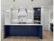 Modern kitchen with white and blue cabinetry, a large island, and quartz countertops at 2735 Marie Way, Cumming, GA 30028