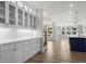 Elegant kitchen boasts white cabinets, quartz countertops, and a blue island at 2735 Marie Way, Cumming, GA 30028