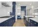 Modern kitchen with stainless steel appliances, white and blue cabinets and a herringbone backsplash at 2735 Marie Way, Cumming, GA 30028