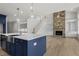 Modern kitchen with island, stainless steel appliances, and blue cabinetry at 2735 Marie Way, Cumming, GA 30028